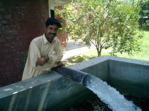 Farmer showing how generously his well is flowing